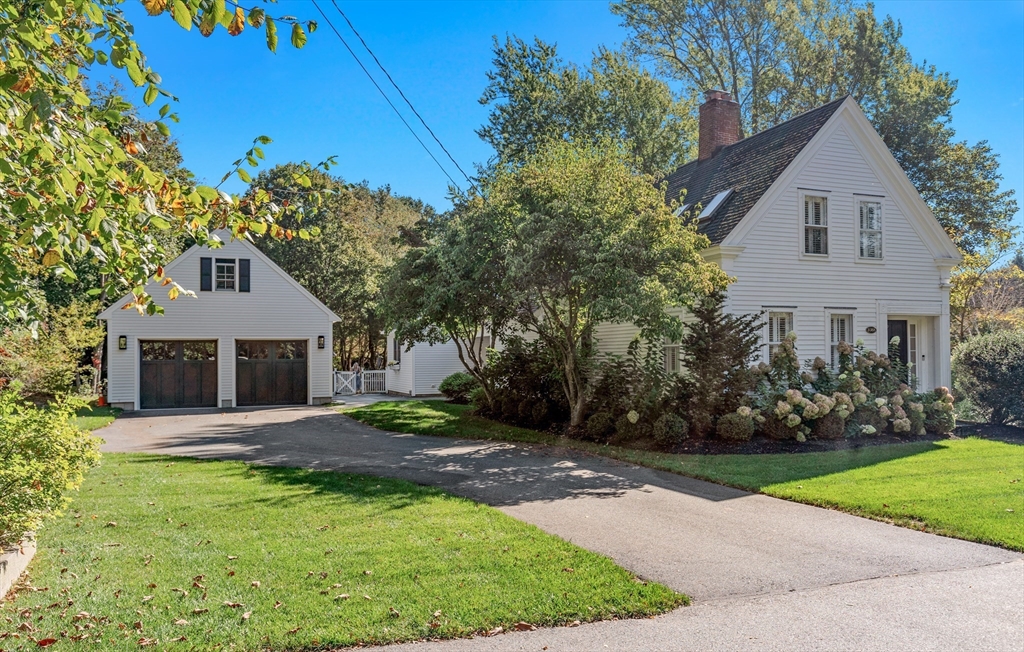 1088 Main Street Hingham, MA 02043 - Photo 2 of 37 a front view of a house with a garden