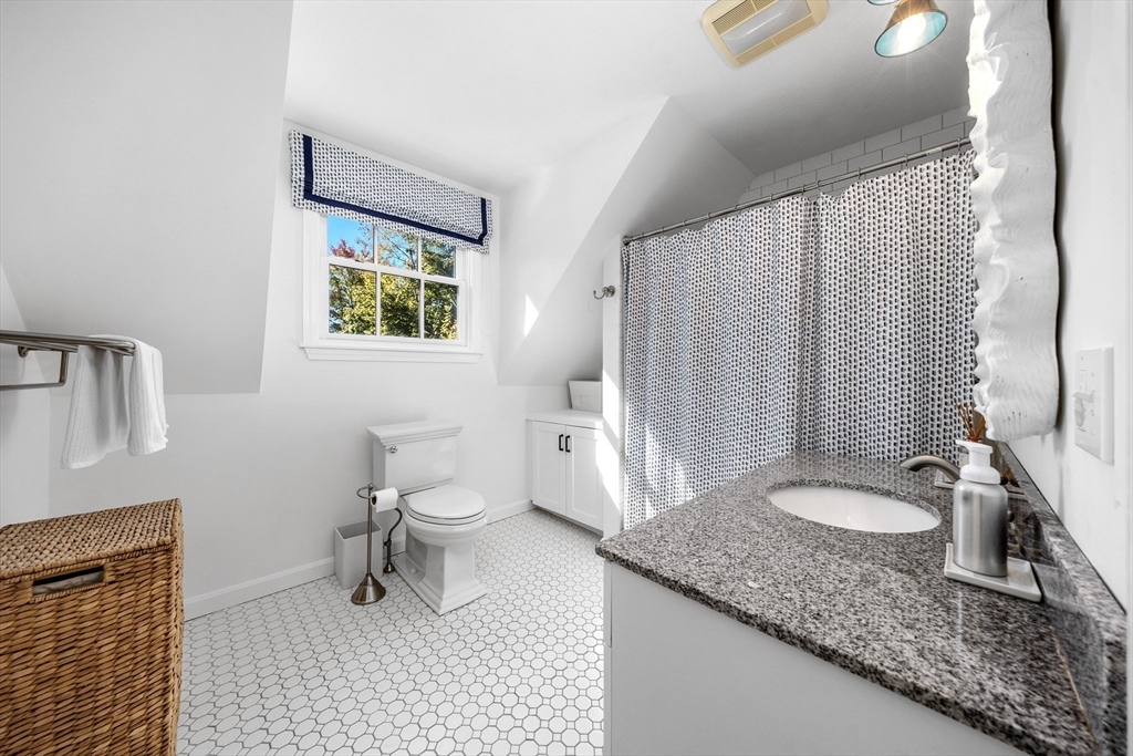 1088 Main Street Hingham, MA 02043 - Photo 24 of 37 a bathroom with a granite countertop sink a toilet and a bathtub