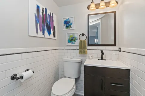 a bathroom with a toilet a sink and mirror