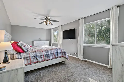 a bedroom with a bed closet and flat screen tv