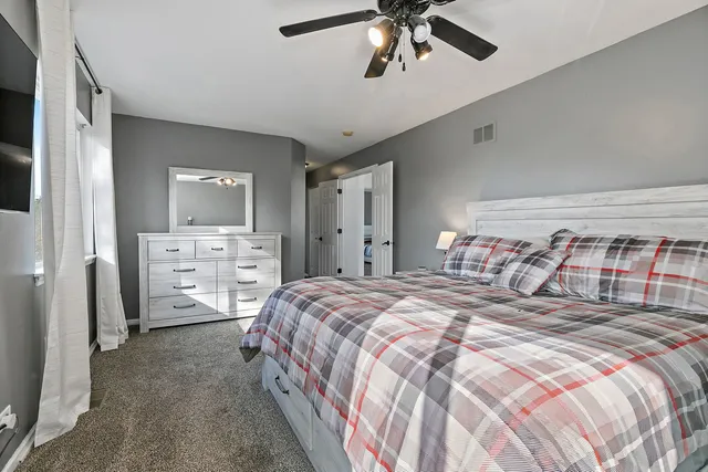 a bedroom with a bed and a chandelier