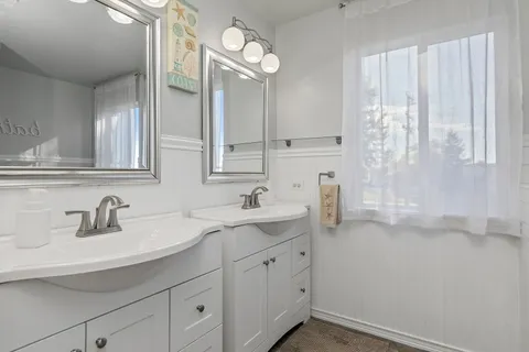 a bathroom with a sink double vanity and a mirror