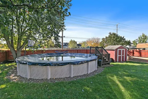 a view of a backyard with large tree