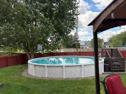 a view of house with a yard and deck