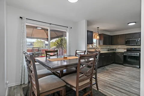 a dining room with furniture and large windows