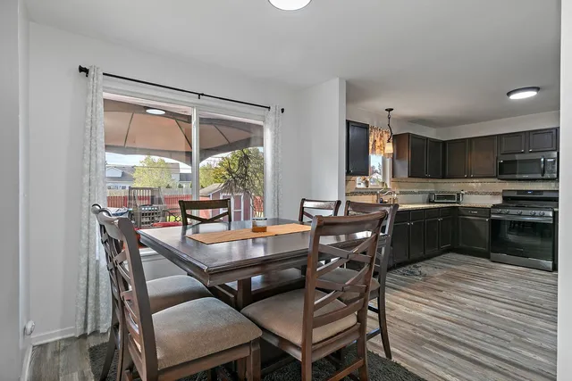 a dining room with furniture and large windows