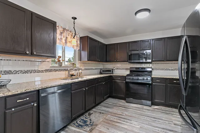 a kitchen with a sink stove and refrigerator