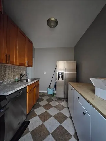 a kitchen with stainless steel appliances granite countertop a sink stove and cabinets