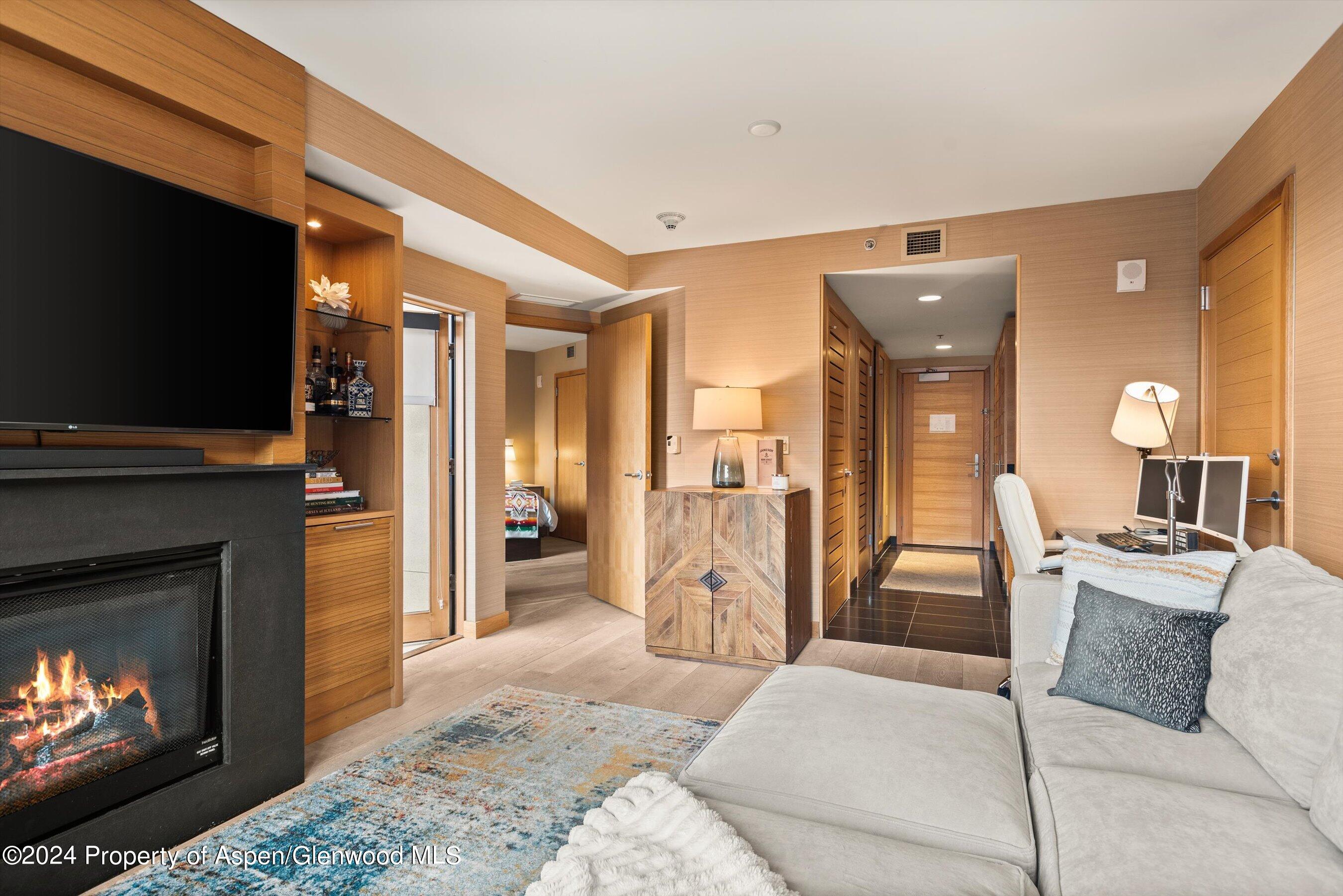 130 Wood Road, Unit 514 Snowmass Village, CO 81615 - Photo 3 of 11 a living room with furniture and a fireplace