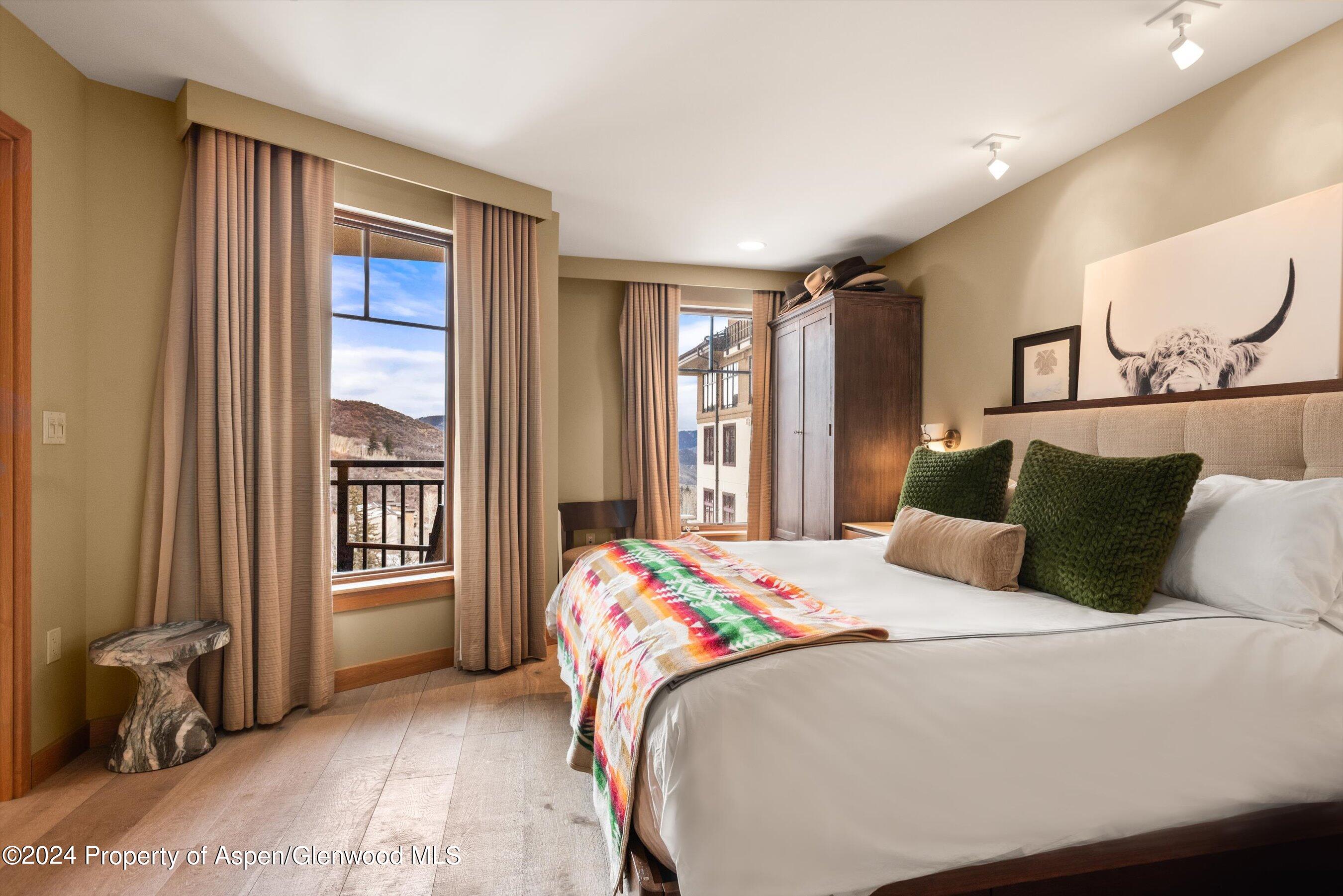 130 Wood Road, Unit 514 Snowmass Village, CO 81615 - Photo 6 of 11 a bedroom with a large bed and a window