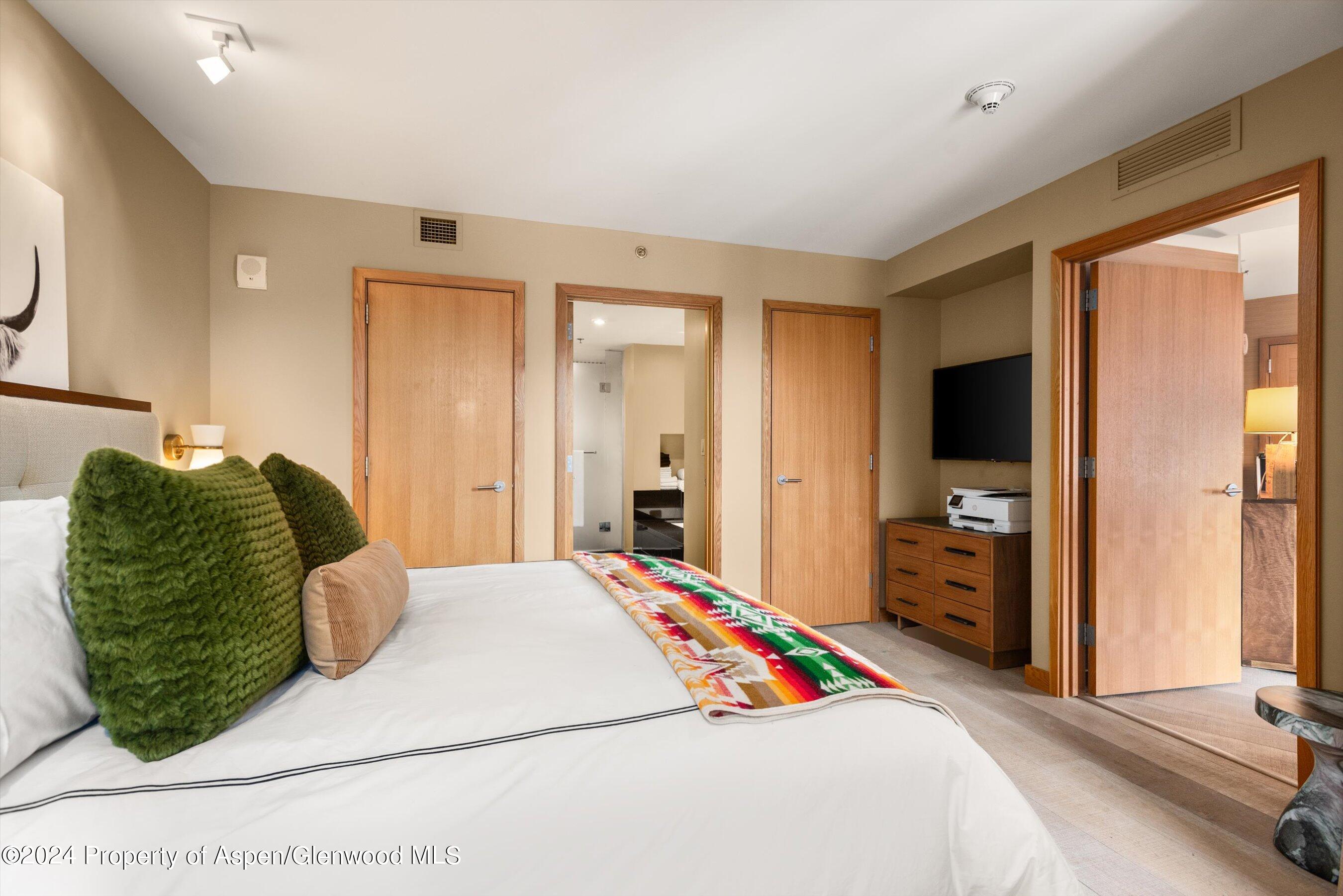 130 Wood Road, Unit 514 Snowmass Village, CO 81615 - Photo 7 of 11 a bedroom with a large bed and a large window