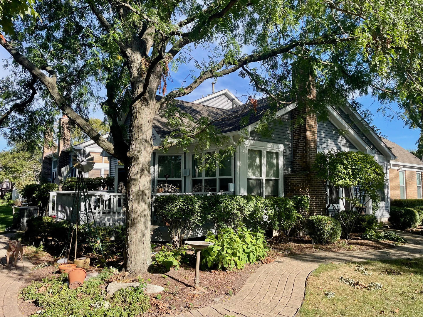 923 Heathrow Lane Naperville, IL 60540 - Photo 2 of 4 a yellow house with trees in front of it