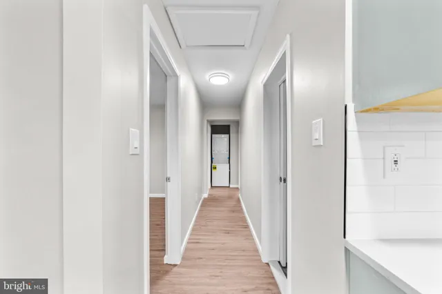 a view of a hallway with wooden floor