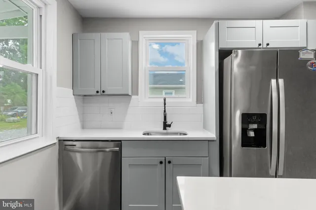 a kitchen with stainless steel appliances a refrigerator and a sink