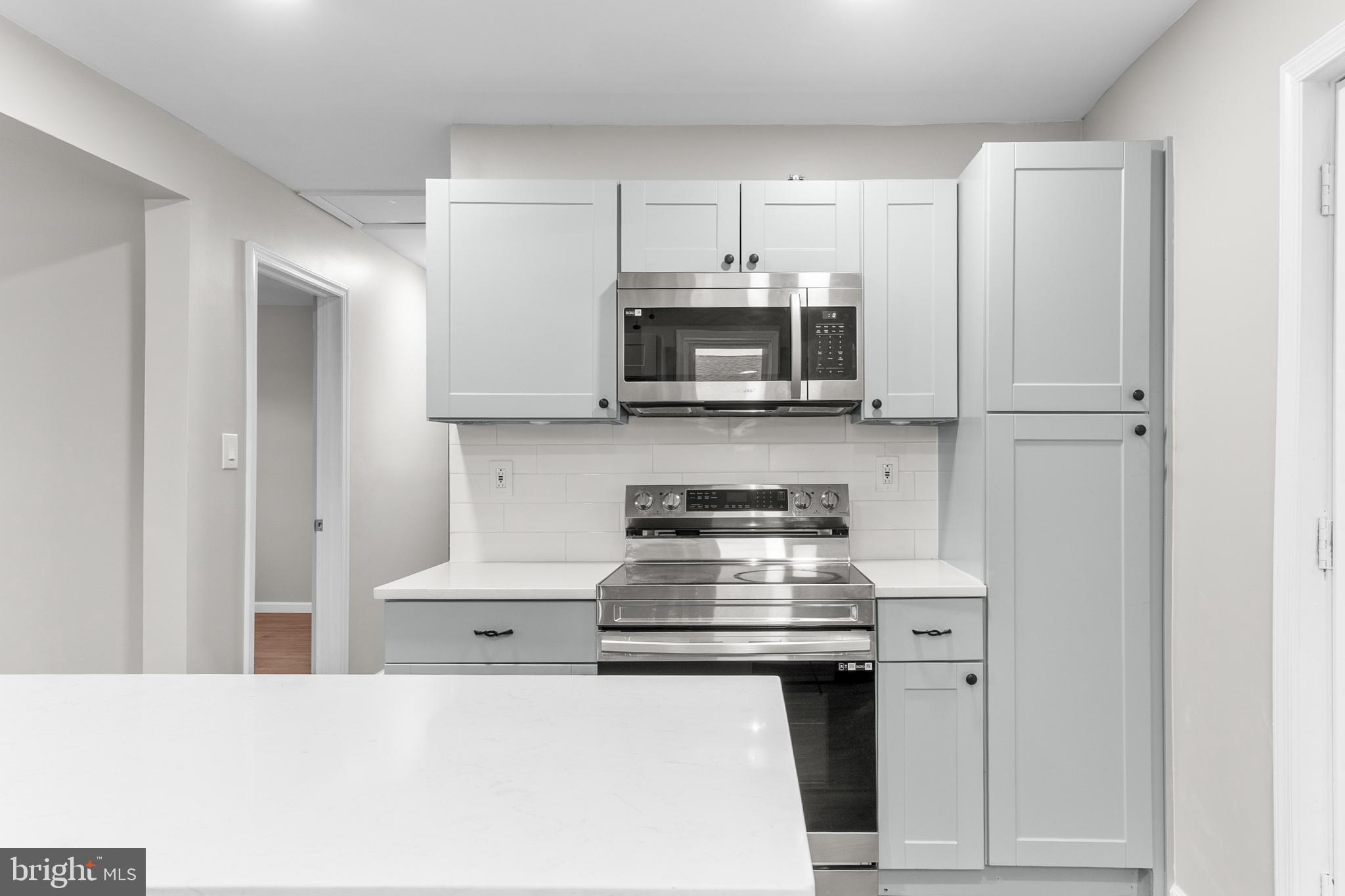 22 Alloway Road Woodstown, NJ 08098 - Photo 6 of 22 a kitchen with stainless steel appliances a stove microwave and sink