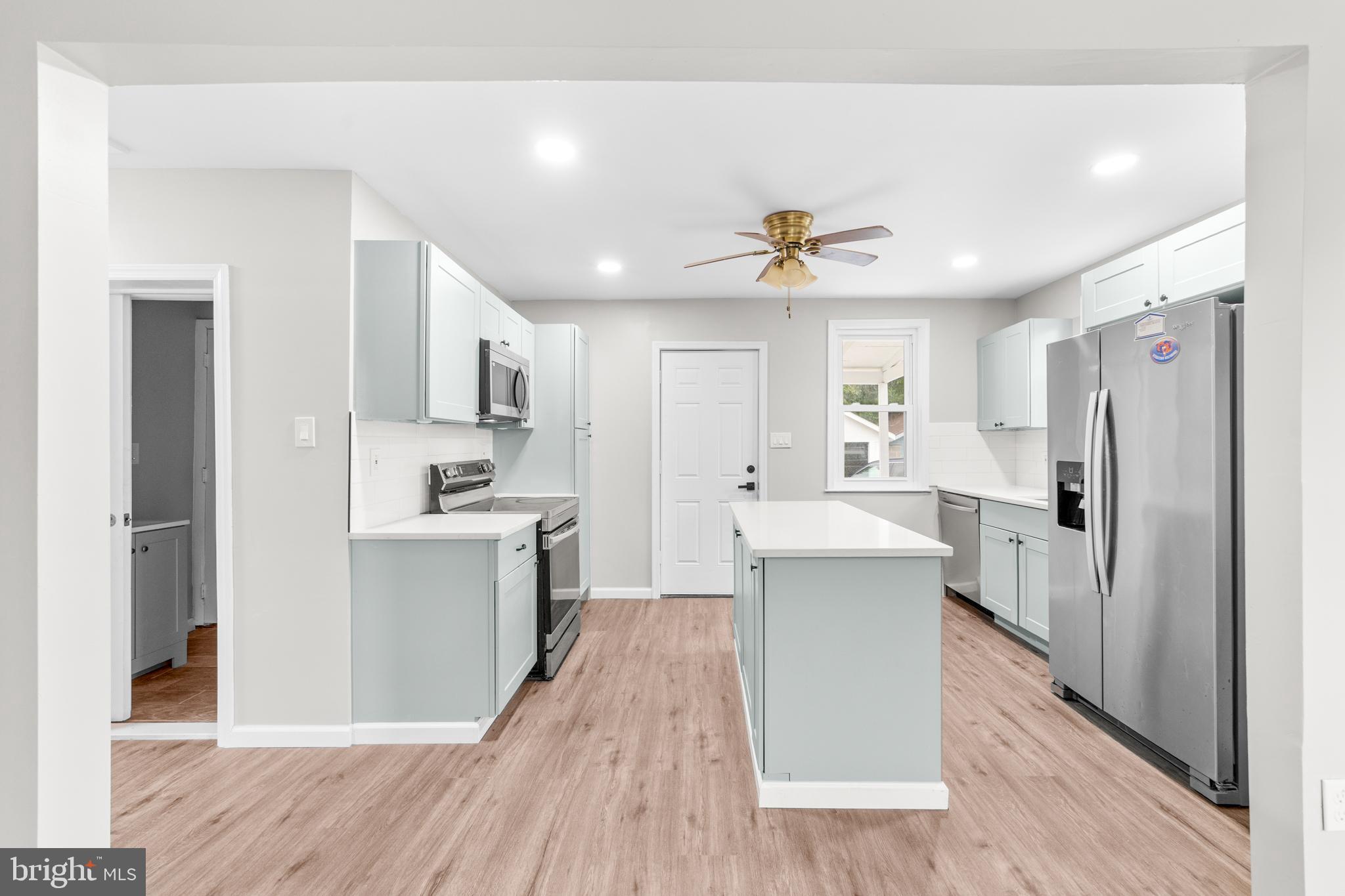 22 Alloway Road Woodstown, NJ 08098 - Photo 8 of 22 a kitchen with a refrigerator a sink and dishwasher with wooden floor