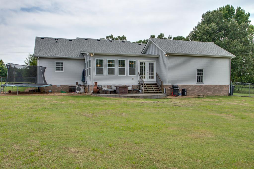 1099 Jump Off Road Bon Aqua, TN 37025 - Photo 14 of 16 a front view of house with yard and car parked