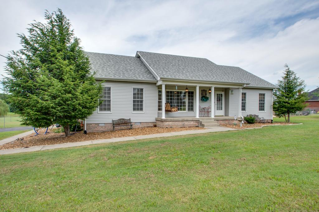 1099 Jump Off Road Bon Aqua, TN 37025 - Photo 16 of 16 a front view of a house with a yard and trees