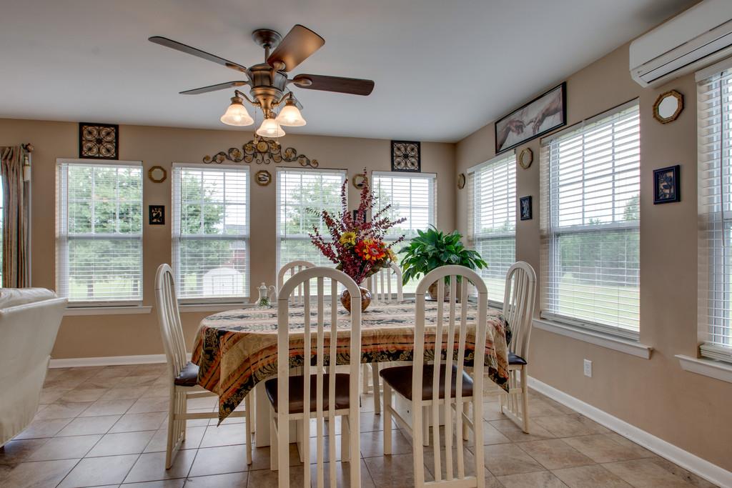 1099 Jump Off Road Bon Aqua, TN 37025 - Photo 5 of 16 a dining room with furniture a potted plant and a chandelier