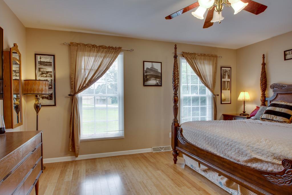1099 Jump Off Road Bon Aqua, TN 37025 - Photo 7 of 16 a bedroom with a bed next to a window
