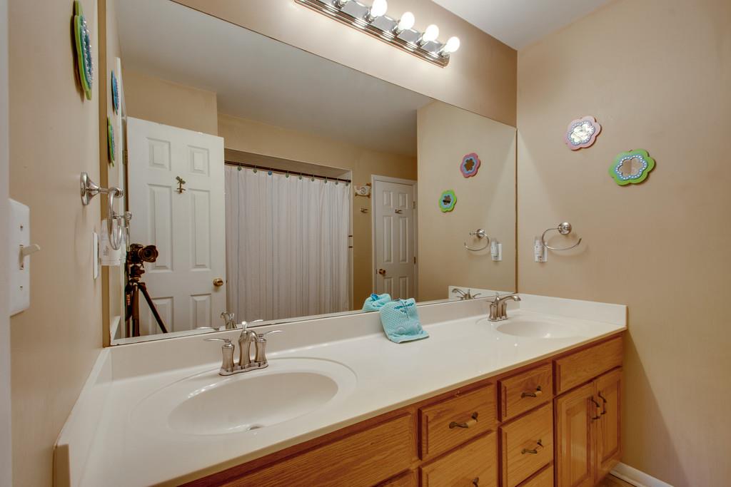 1099 Jump Off Road Bon Aqua, TN 37025 - Photo 8 of 16 a bathroom with a sink double vanity and a mirror