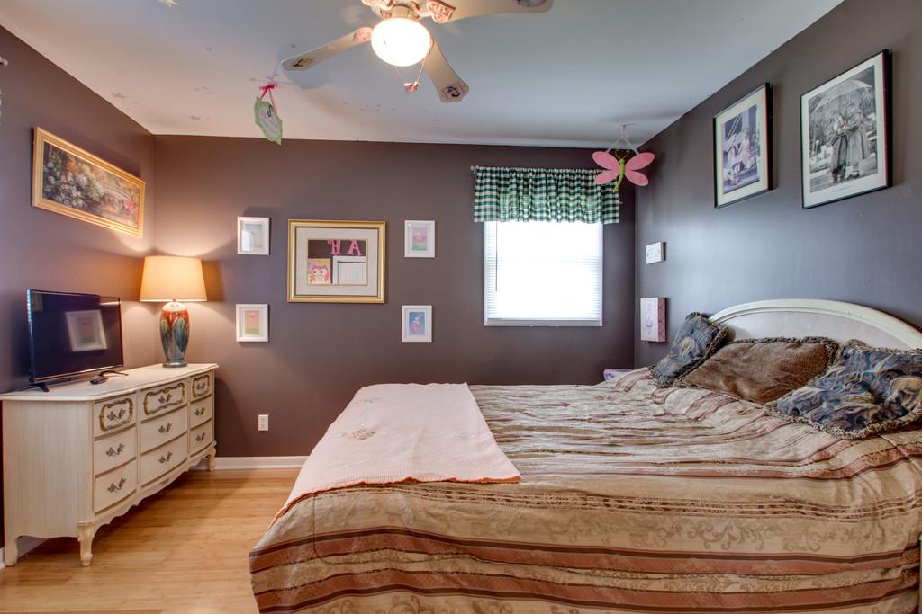 1099 Jump Off Road Bon Aqua, TN 37025 - Photo 9 of 16 a bedroom with a bed and a dresser