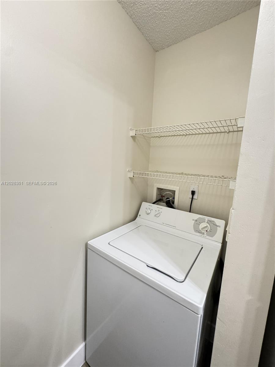 2021 Renaissance Boulevard, Unit 201 Miramar, FL 33025 - Photo 10 of 26 a utility room with dryer and washer