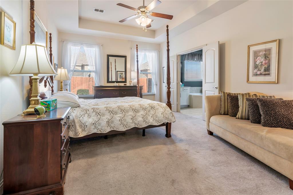 1012 Sweeping Butte Drive Fort Worth, TX 76052 - Photo 11 of 23 a bedroom with a bed couch chandelier and a window