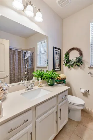 a bathroom with a sink a toilet and mirror