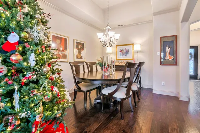 a view of a dining room with furniture and chandelier