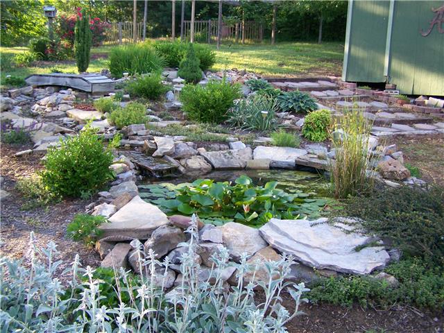 1390 Porter Morris Road Chapmansboro, TN 37035 - Photo 12 of 20 The custom pond has a recirculating pump that feeds the water down a small stream into the main pond itself. Surrounded by tranquil landscaping and enhanced with tropical plants.