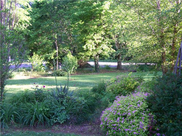 1390 Porter Morris Road Chapmansboro, TN 37035 - Photo 17 of 20 The home itself sets back ample distance from the main road. Boarded by trees and a decorative split rail fence.