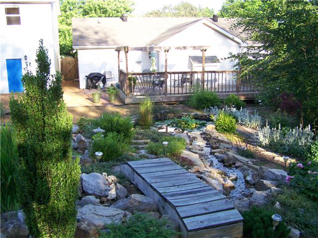 1390 Porter Morris Road Chapmansboro, TN 37035 - Photo 2 of 20 This beautiful sunlit deck overlooks gardens and a custom pond.