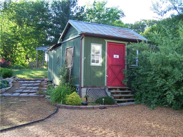 1390 Porter Morris Road Chapmansboro, TN 37035 - Photo 4 of 20 This quaint storage barn is behind the garage located just off the deck area behind the home. A great place to store your garden equipment & mower.