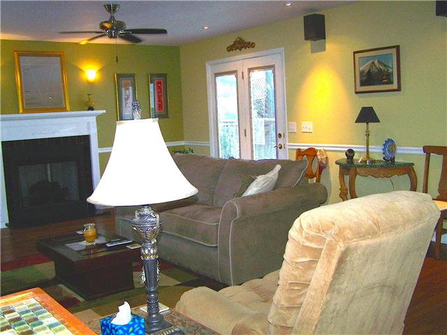1390 Porter Morris Road Chapmansboro, TN 37035 - Photo 6 of 20 The french doors off to the right lead out to the rear deck. This room is large enough to have a formal dining space at one end of the room and full size living room furnature to gather around the fireplace.