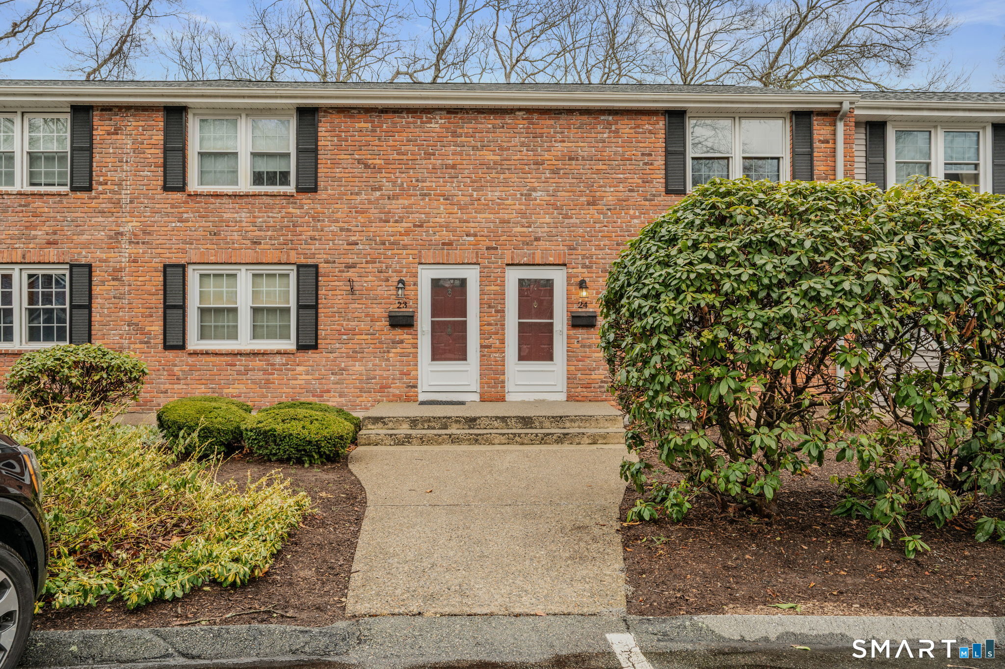 front view of a brick house with a yard