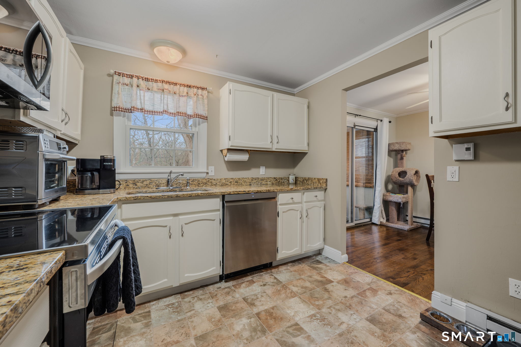 81 East Pattagansett Road, Unit 24 East Lyme, CT 06357 - Photo 15 of 29 a kitchen with a sink stove and cabinets