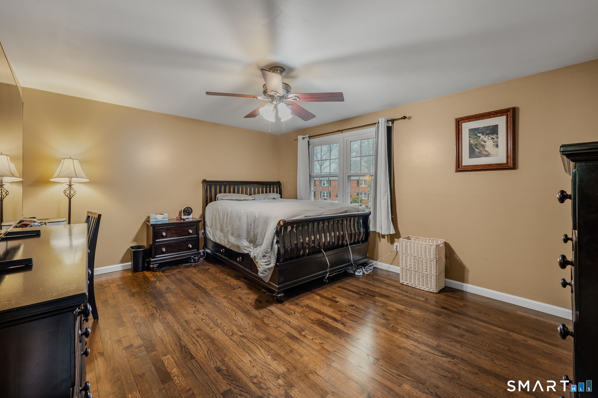 81 East Pattagansett Road, Unit 24 East Lyme, CT 06357 - Photo 17 of 29 a bedroom with a bed and wooden floor
