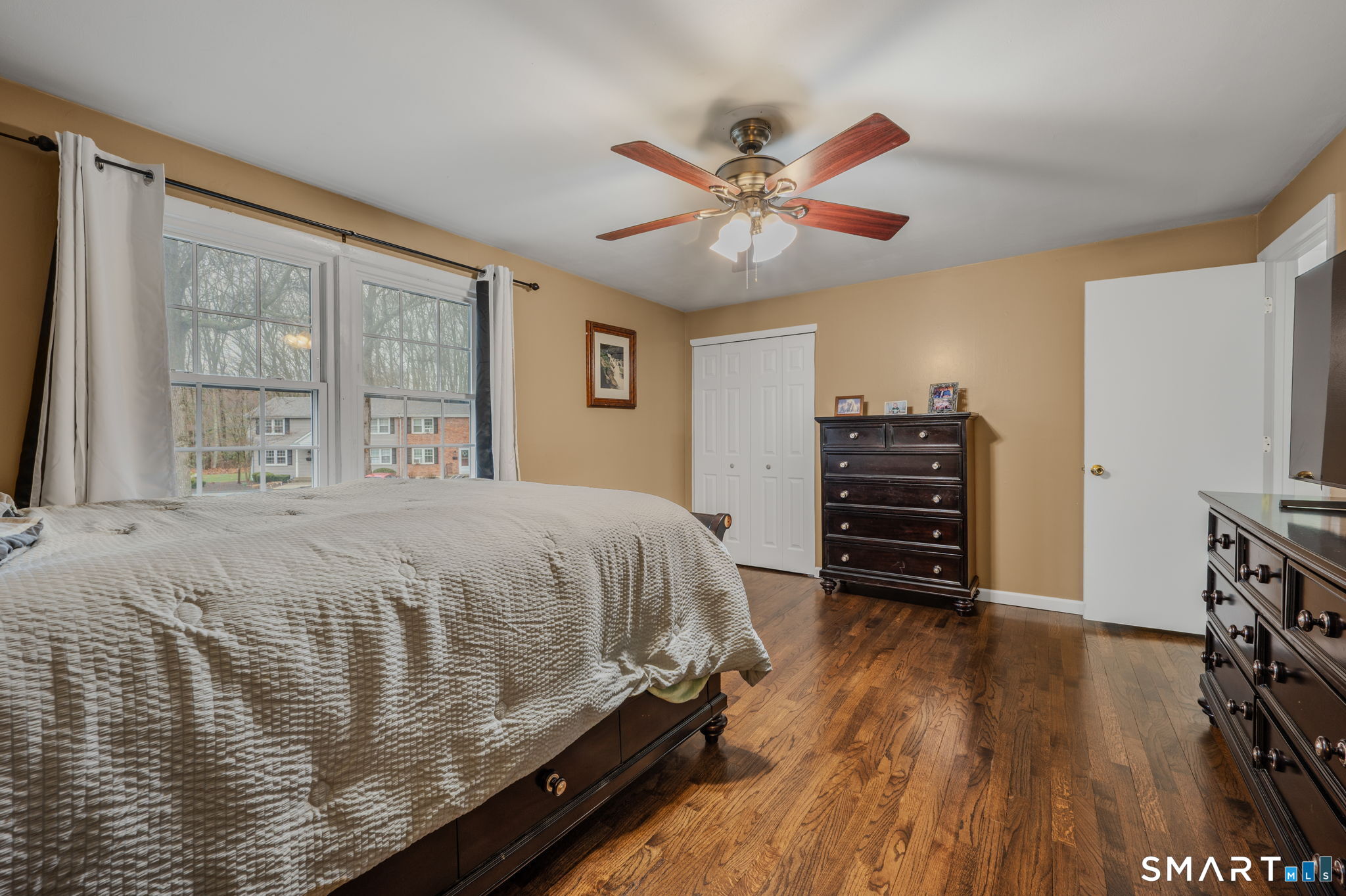 81 East Pattagansett Road, Unit 24 East Lyme, CT 06357 - Photo 19 of 29 a bedroom with a bed closet and flat screen tv
