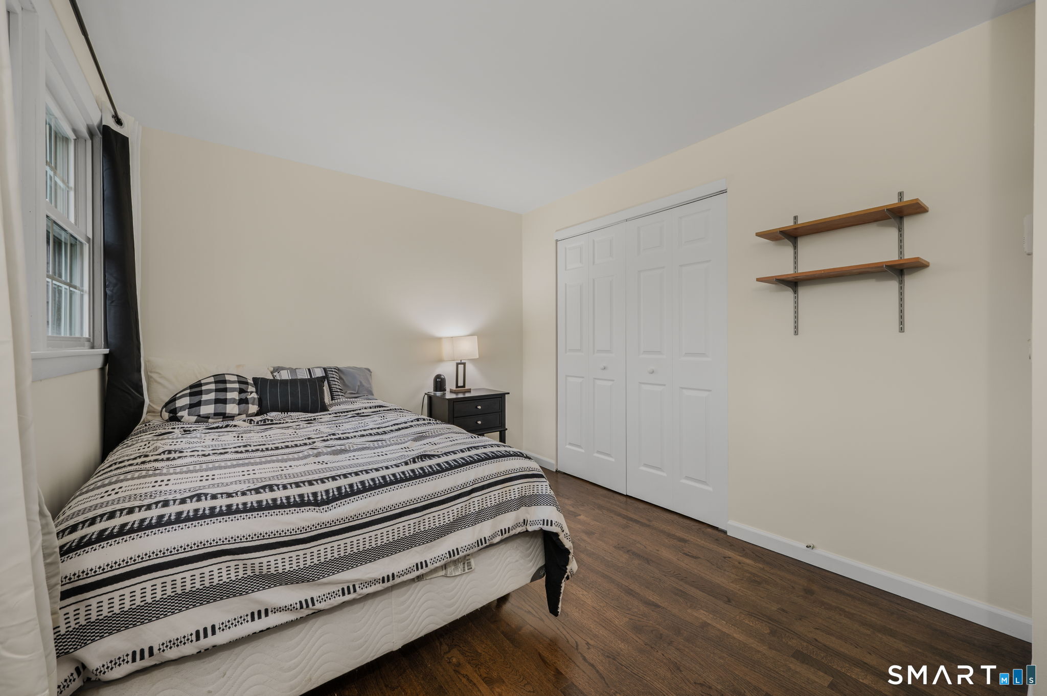 81 East Pattagansett Road, Unit 24 East Lyme, CT 06357 - Photo 20 of 29 a bedroom with a bed and wooden floor