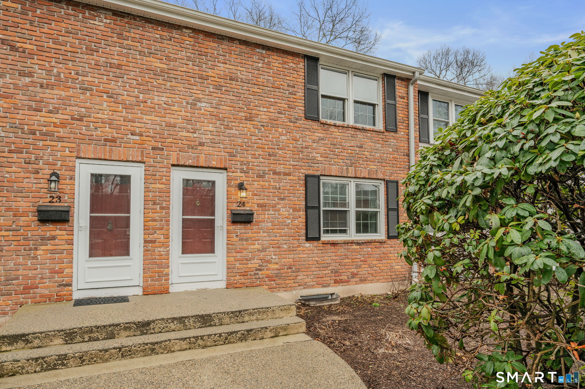 81 East Pattagansett Road, Unit 24 East Lyme, CT 06357 - Photo 2 of 29 a front view of a house with a yard