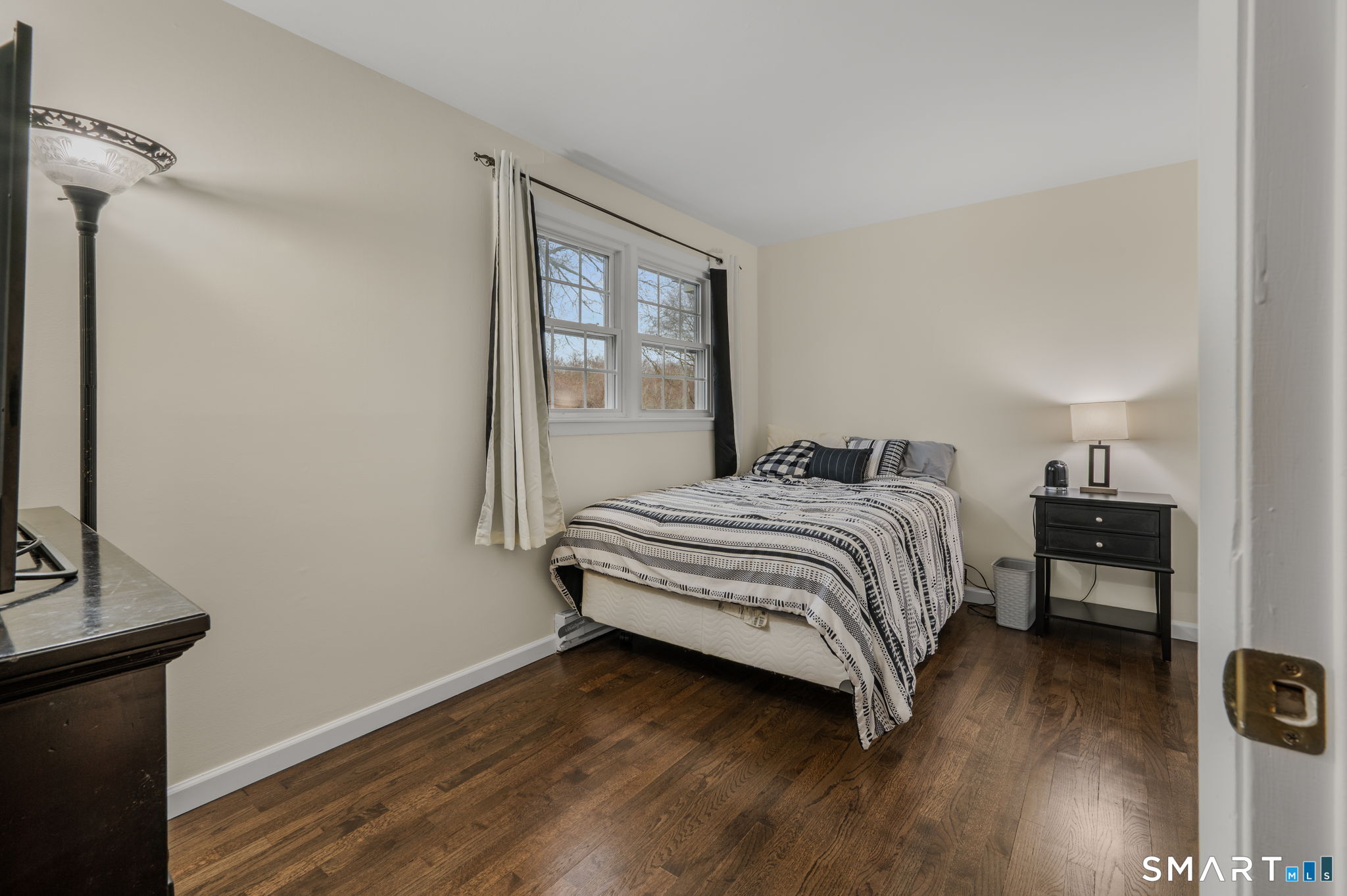 81 East Pattagansett Road, Unit 24 East Lyme, CT 06357 - Photo 22 of 29 a bedroom with a bed and wooden floor