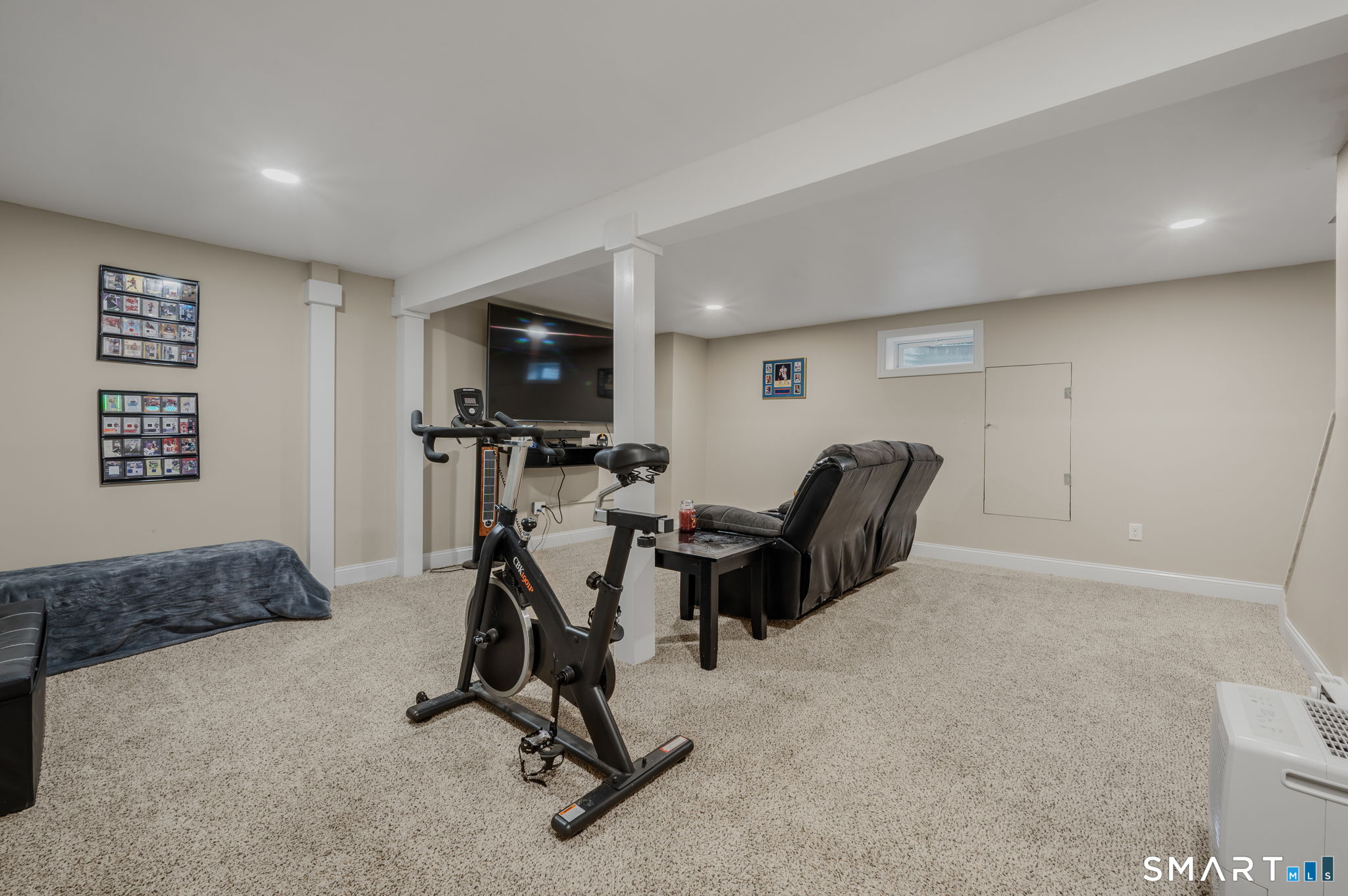 81 East Pattagansett Road, Unit 24 East Lyme, CT 06357 - Photo 24 of 29 a living room with furniture and a flat screen tv