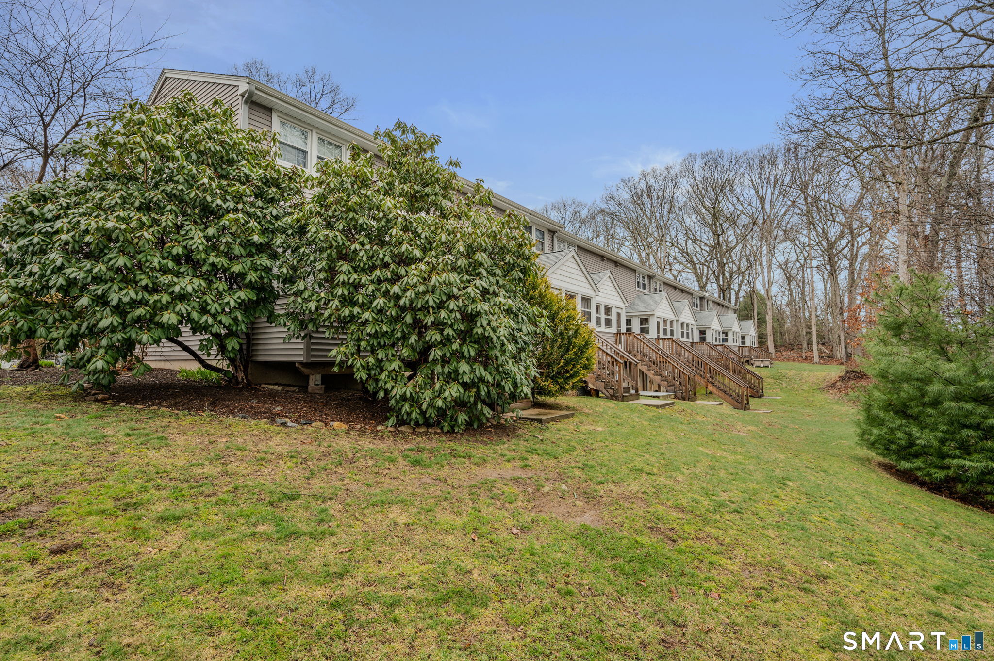 81 East Pattagansett Road, Unit 24 East Lyme, CT 06357 - Photo 5 of 29 a view of a yard with plants and trees