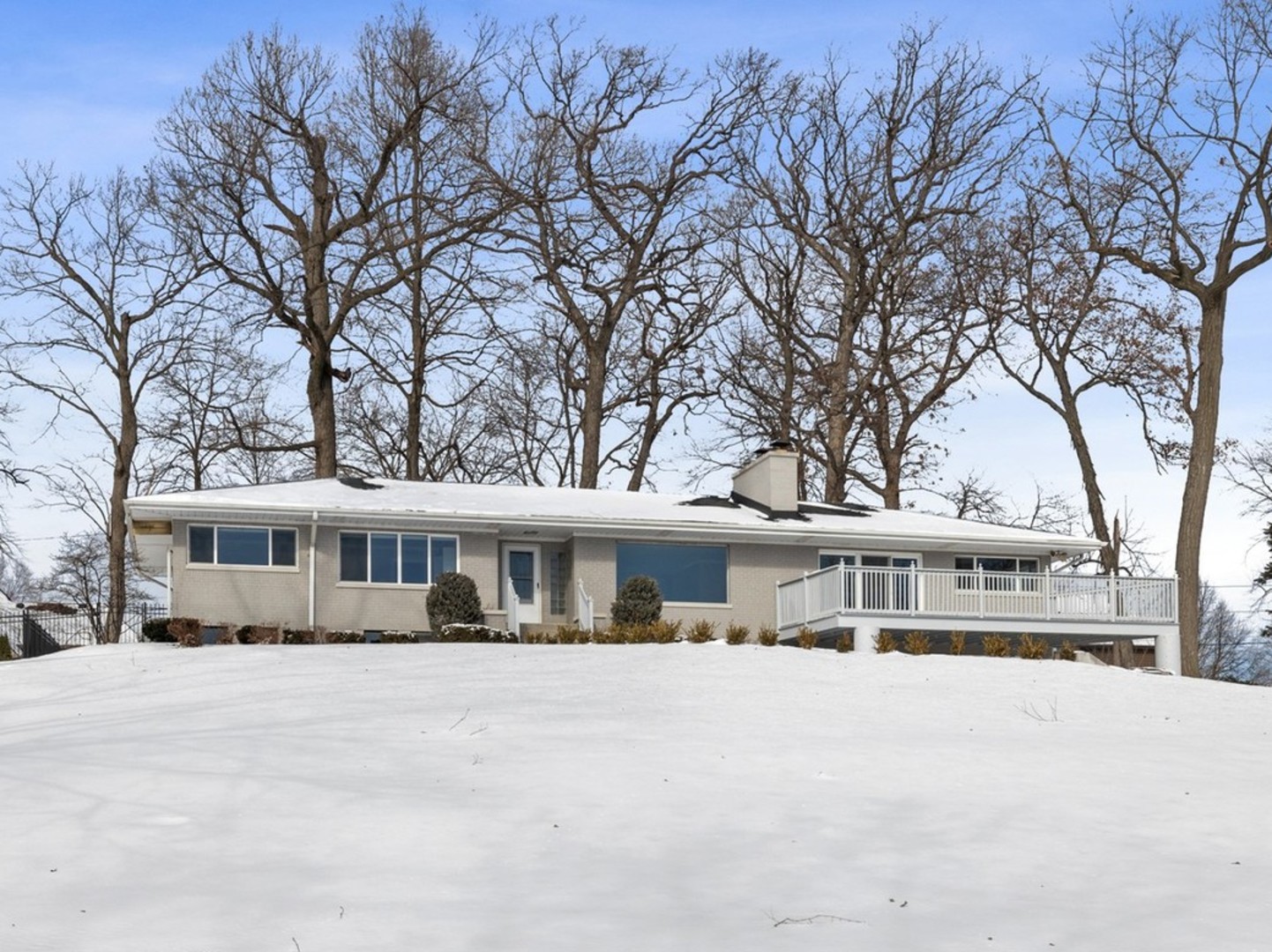 21-w064 Shelley Drive Itasca, IL 60143 - Photo 1 of 24 a front view of a building with large trees