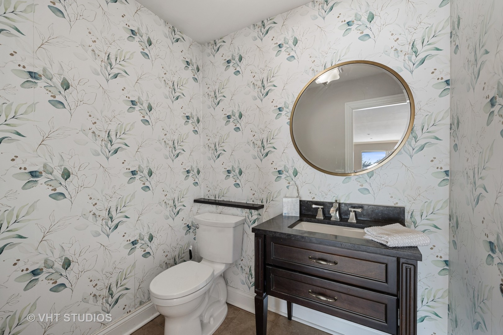 21-w064 Shelley Drive Itasca, IL 60143 - Photo 11 of 24 a bathroom with a granite countertop toilet sink mirror and vanity