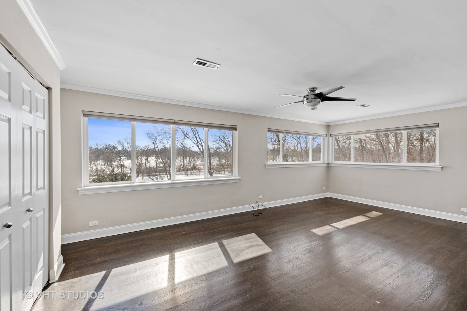 21-w064 Shelley Drive Itasca, IL 60143 - Photo 12 of 24 a view of an empty room with a window and wooden floor