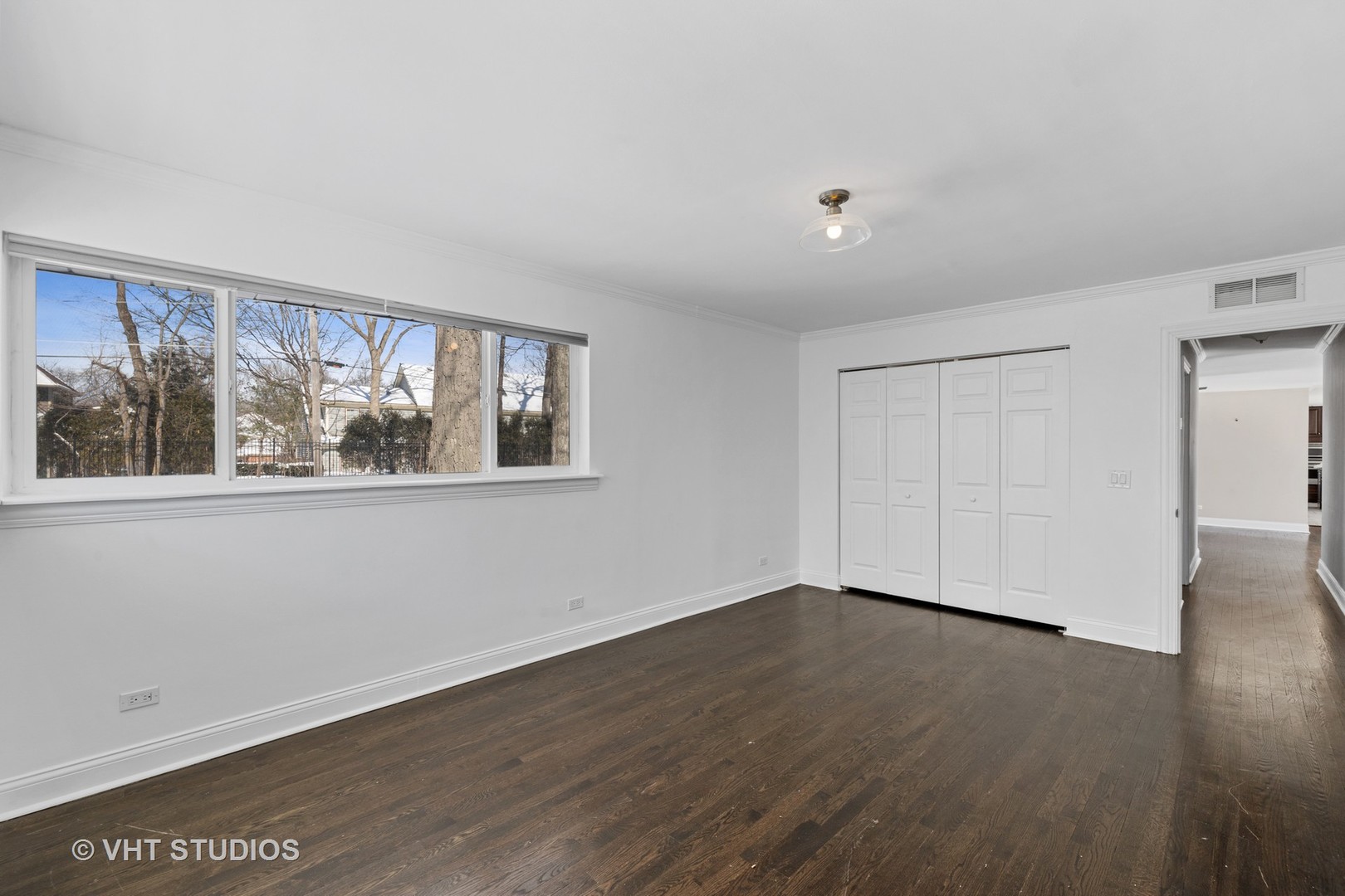 21-w064 Shelley Drive Itasca, IL 60143 - Photo 13 of 24 a view of an empty room with wooden floor and a window