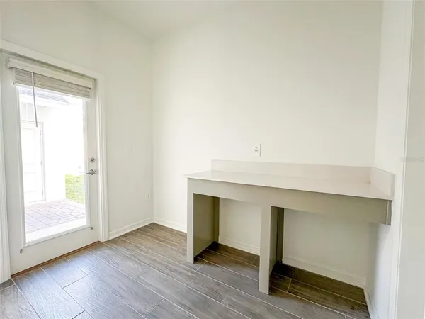 a hallway with a wooden floor and a table