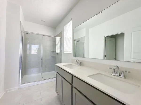 a bathroom with a sink double vanity and a mirror